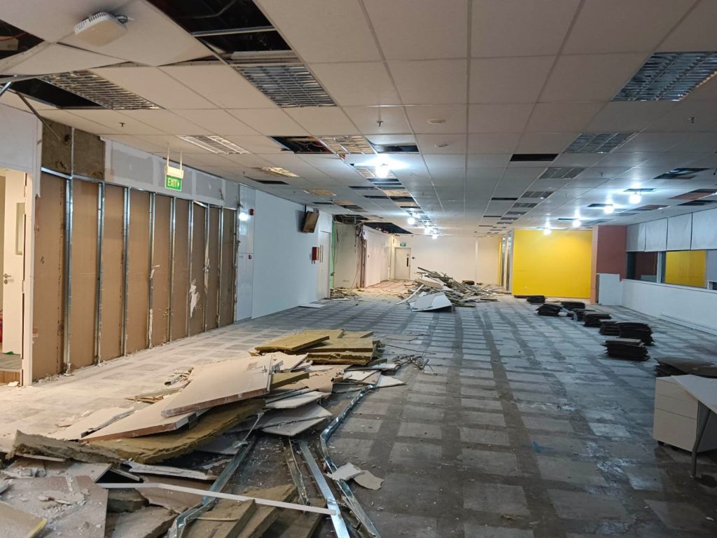Commercial construction team at work on a modern office renovation in Singapore