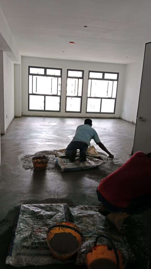 Cement screeding tools like straightedge, trowel, float, and mixing equipment arranged at a worksite.